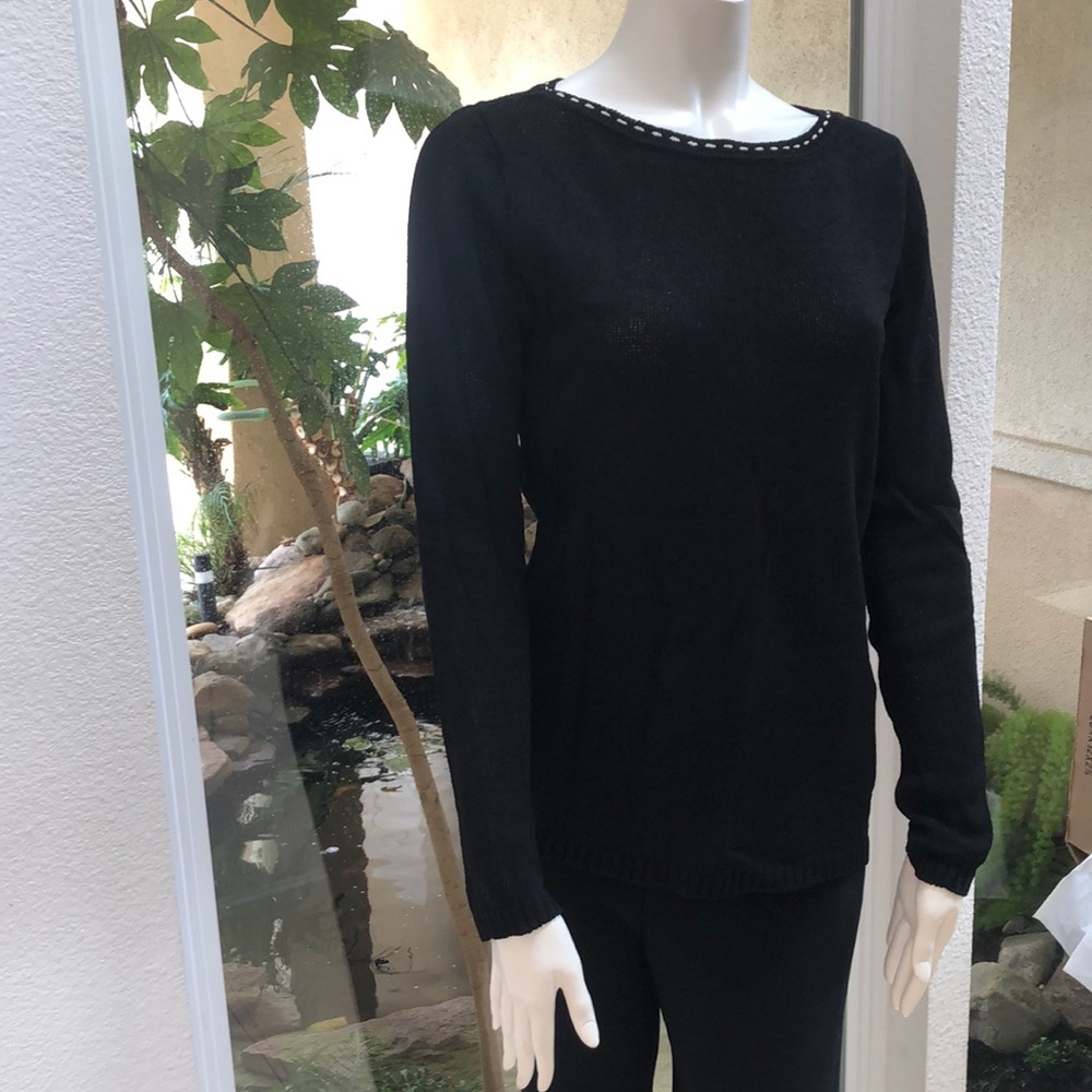 Black knit top with white detail around neckline